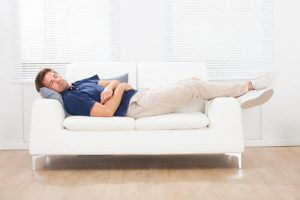 Man sleeping on a white couch
