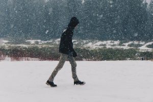 man walking in a snow storm