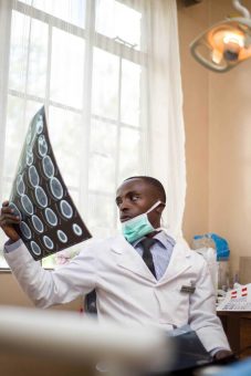 Dentist examines X-ray