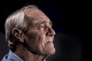 Elderly man with hearing aid