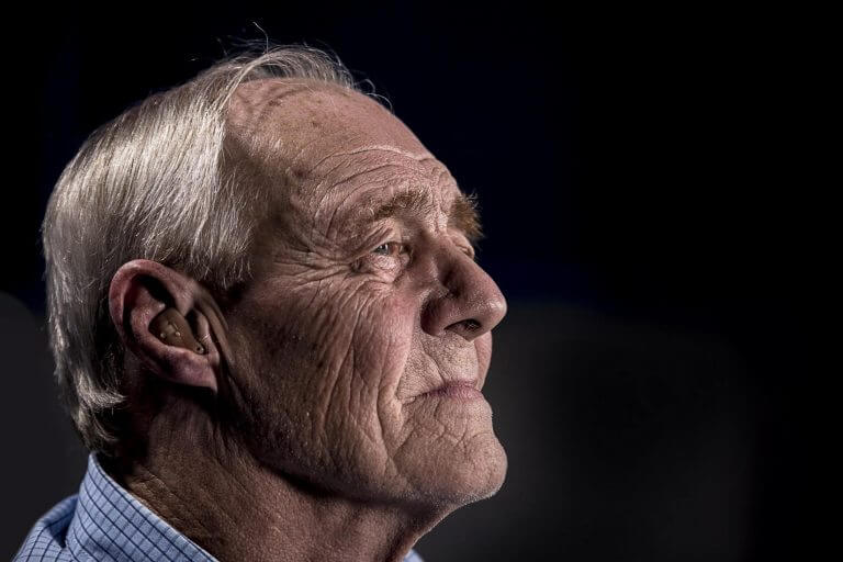 Elderly man with hearing aid