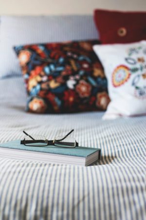 pillows and book on bed