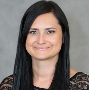 Woman with long dark hair smiling