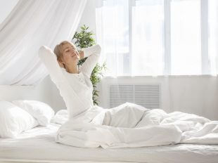 woman waking up from a restful night of sleep