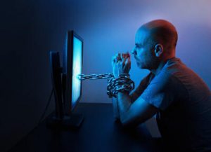 Man chained to computer screen