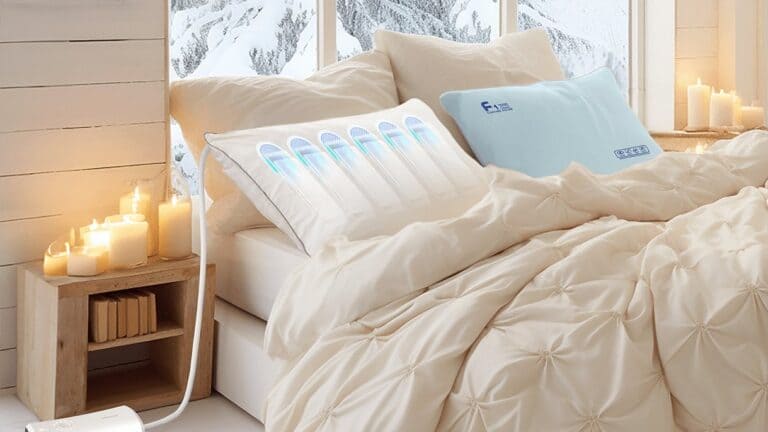 Nitetronic Z6 smart anti-snore pillow with glowing air chambers on a made bed beside a nightstand