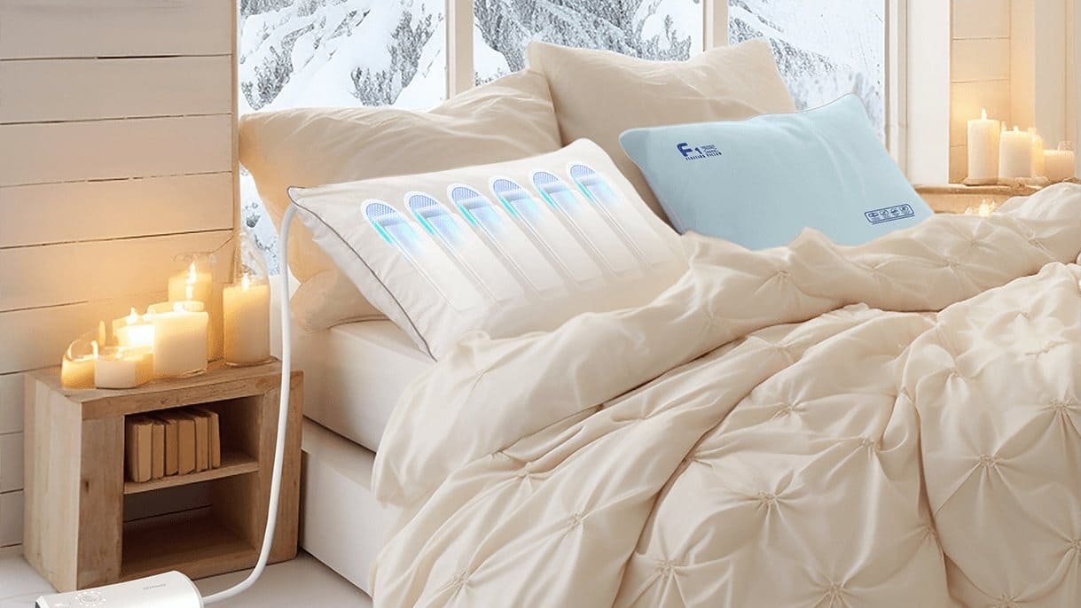 Nitetronic Z6 smart anti-snore pillow with glowing air chambers on a made bed beside a nightstand